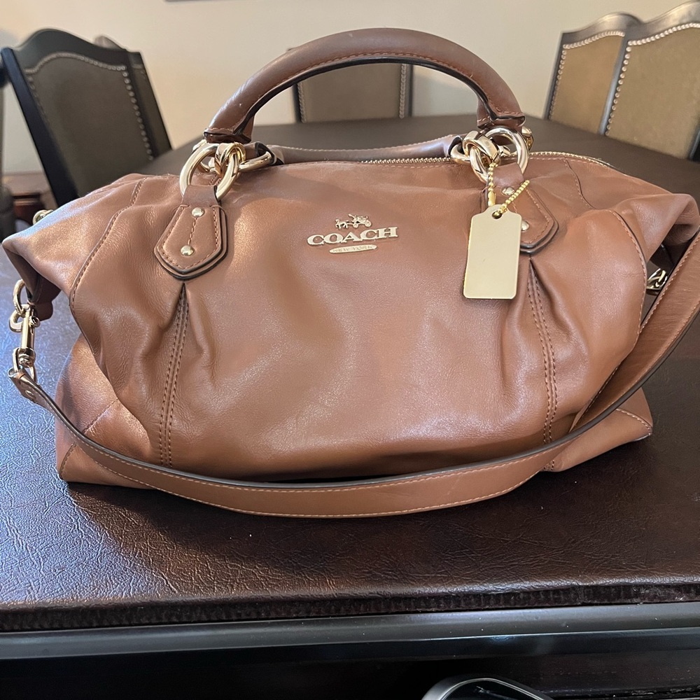 Coach tan leather satchel. Gold zip top closure, shoulder strap